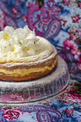 Delicate curd pudding with icing sugar gerberas         