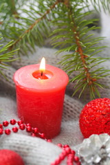 Obraz na płótnie Canvas Red candle with christmas decoration