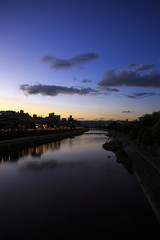 Obraz premium The Kamogawa River in Kyoto, Japan is popular walking spots for tourists. In summer, restaurants open balconies looking out to the river.