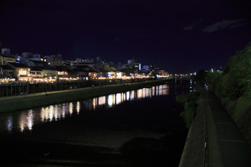 Obraz premium The Kamogawa River in Kyoto, Japan is popular walking spots for tourists. In summer, restaurants open balconies looking out to the river.