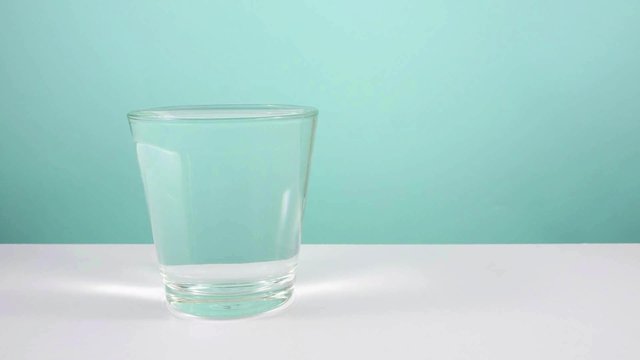 Animation of water filling up an empty glass.