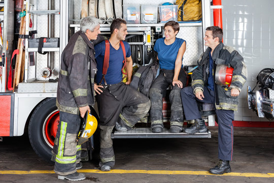 Firefighters Conversing At Fire Station