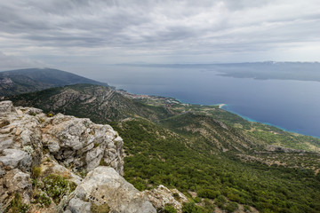 Fototapeta na wymiar Scenic view from top of the Vidova Gora Mountain towards Bol and Zlatni Rat Beach at the Brac Island in Croatia.