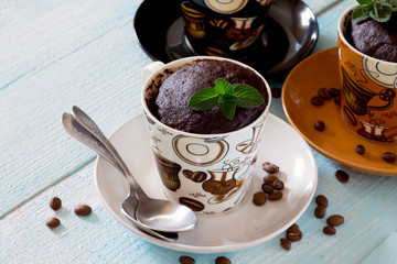 Quick chocolate coffee cake in a cup on a wooden table