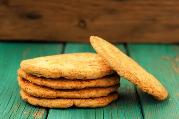 Yummy homemade almond cookies in pile on turquoise shabby backgr