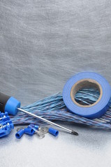 Electrical tools, component and cables on metal surface with place for text