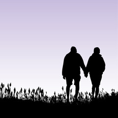 A man and woman walking on the beach
