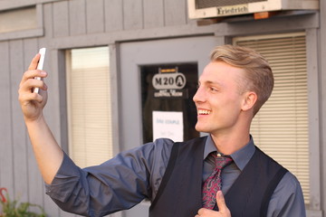 Handsome businessman taking a selfie with a mobile phone