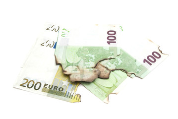 burnt euro banknotes on white