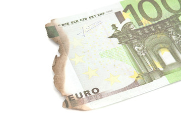 burnt bills of hundred euro on white