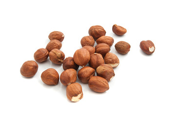 heap of tasty hazelnuts on white