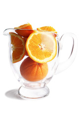 Slices of oranges in pitcher.