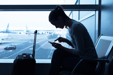 Woman using internet in the airport terminal