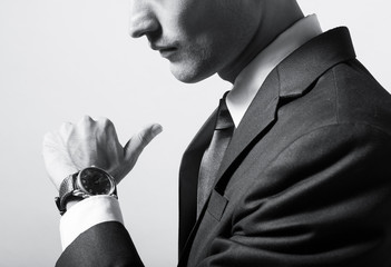 Man checking the time on his wrist watch
