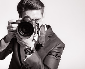 Young man using a professional camera
