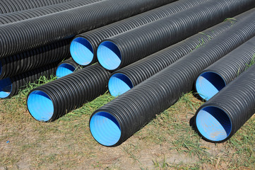 Stacked new PVC pipe on construction site