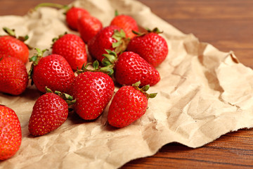 Ripe strawberries on crumples parchment, closeup