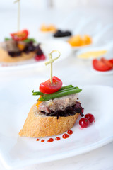 Tasty canapes on wooden table, close up
