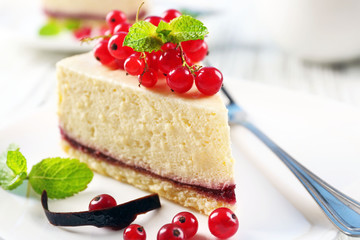 Delicious cheesecake with berries on table close up