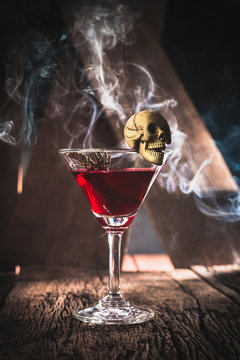 red cocktail with skull halloween party concept