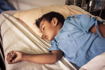 a little asian boy sick sleep on the bed in the hosital,vintage