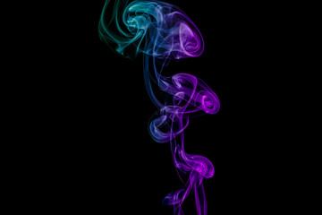 Abstract green and purple smoke from the aromatic sticks.