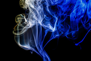 Fototapeta premium Abstract blue and yellow smoke from the aromatic sticks.