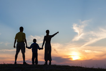 Fototapeta na wymiar Silhouette of family against sunset
