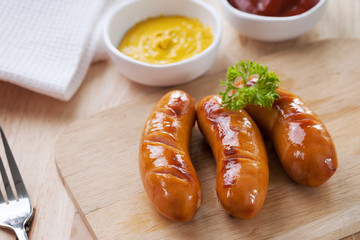 grilled sausage on wooden block