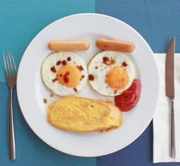 Easy breakfast with bread, fried egg and sausage in white dish