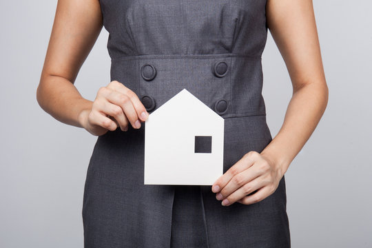 picture of woman holding paper house
