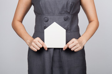 Fototapeta na wymiar picture of woman holding paper house