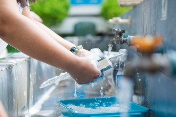 Close up to washing dishes for background.