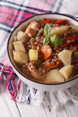 lentil soup with vegetables and meat close up. vertical 
