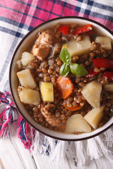 lentil soup with vegetables and meat close up. vertical top view 
