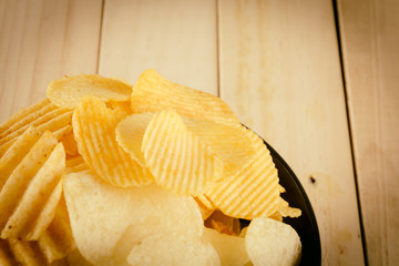 potato chips on wood - soft focus with vintage film filter