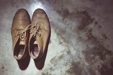Vintage tone of still life with brown leather shoes old