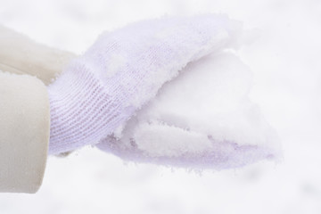 Hand in mittens and snow