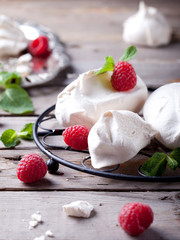 Meringues with fresh berries and mint leaves