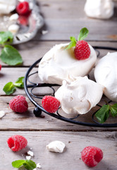 Meringues with fresh berries and mint leaves