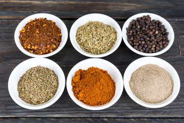 Spices and herbs in  bowls.