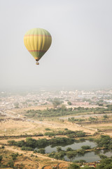 Fototapeta na wymiar flying balloon over land