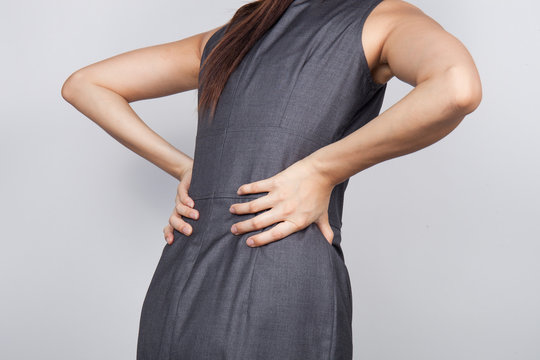 Young businesswoman having back pain