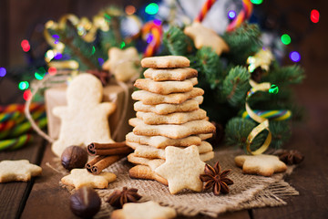 Christmas cookies and tinsel on a dark wooden background