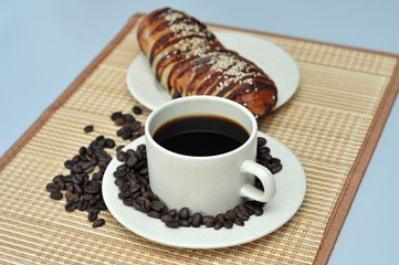 hot coffee with  red bean bread on bamboo mat