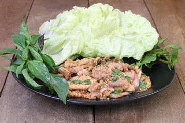Sliced grilled beef salad spicy(NamTok), thai food on wooden table