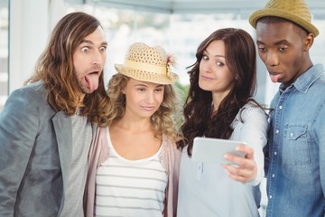 Business team making face while taking selfie 