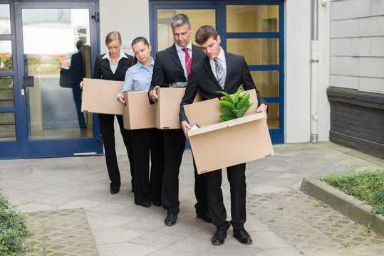 Disappointed Businesspeople With Cardboard Boxes