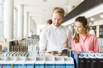 Two students reading and studying in library