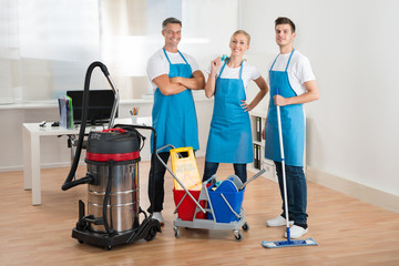 Janitors With Vacuum Cleaner And Cleaning Equipments